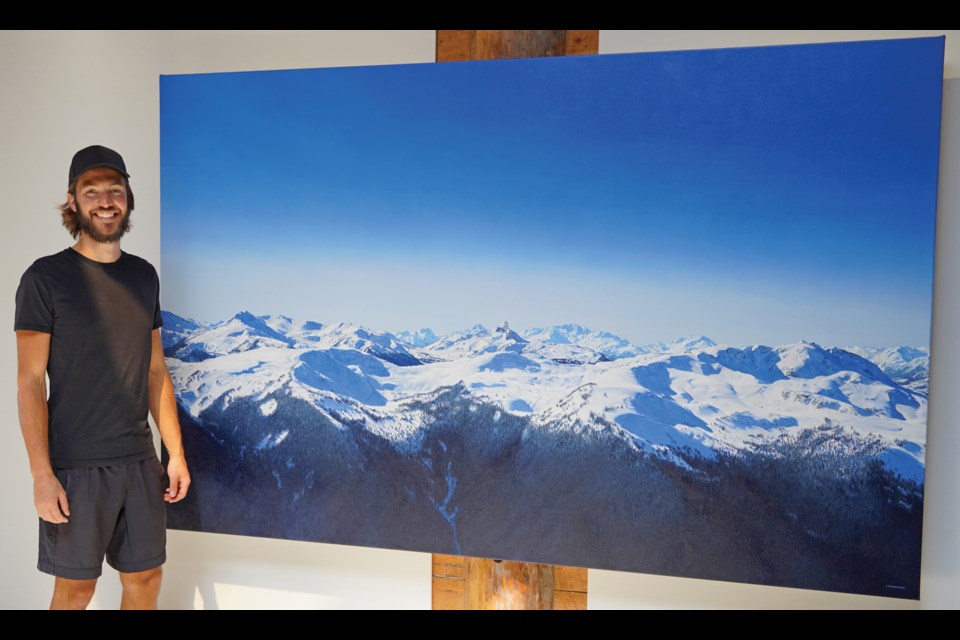 Lucas Kratochwil with one of his striking winter mountain paintings.