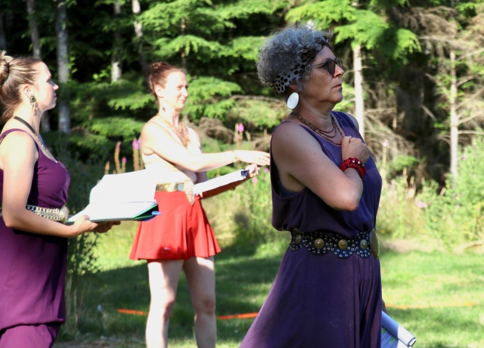 Three women outside staring into the distance