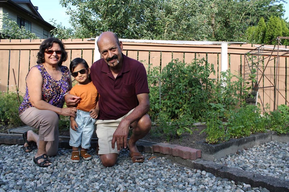 Dharma Singh (right) with this wife Minju Singh and grandson in his herb garden.