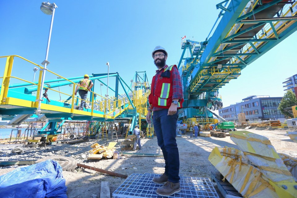 Dave Bukovec, GM of United Engineering, stands in front of the coal stacker-reclaimer which will be shipped to Vancouver in August.