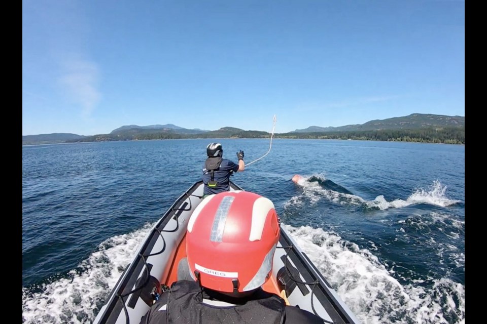 Conservation officers attempt to free a humpback whale from fishing gear and attach a satellite tracking bouy near Gill Island