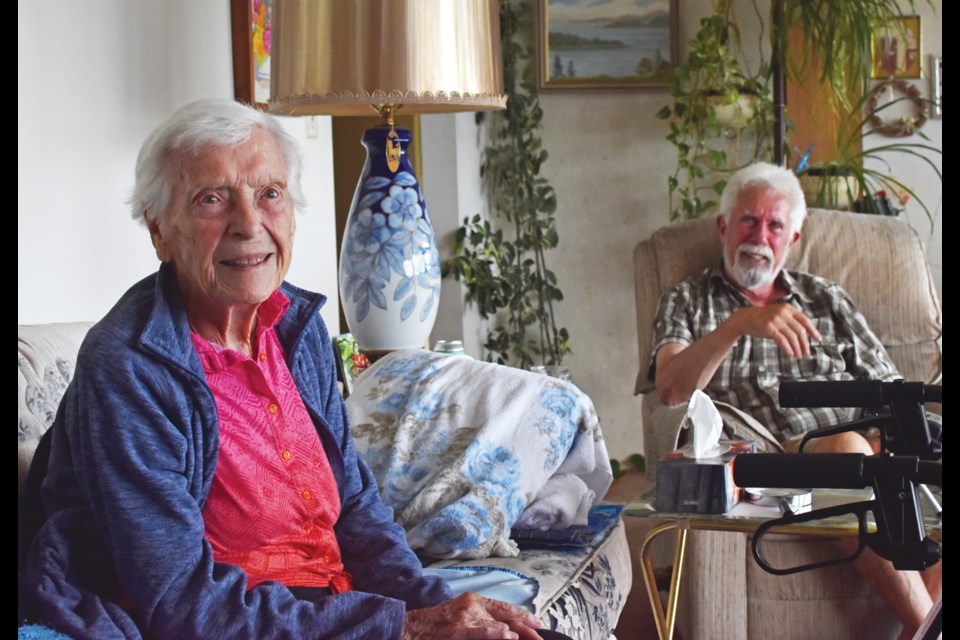 Wilma Sim sits with her youngest son, Clyde Morrison, at her home in Langdale.