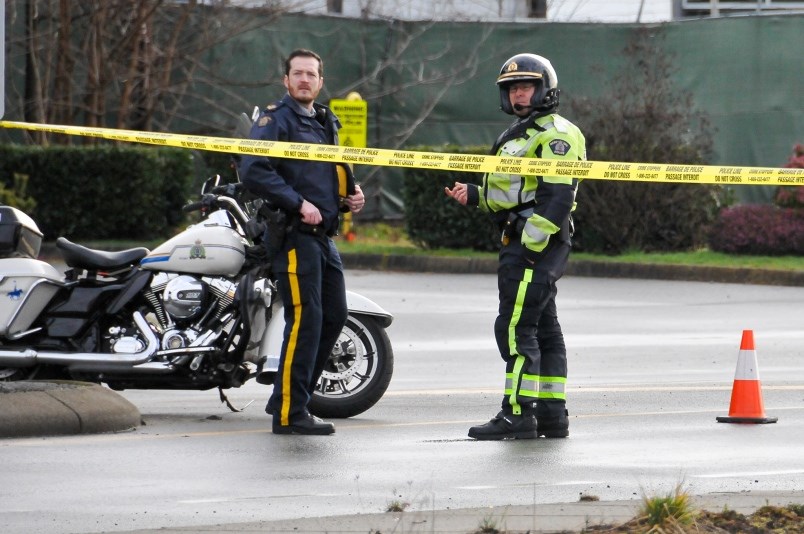 RCMP officer on the scene of a fatal collision in Port Coquitlam involving a van and a cyclist, Feb.