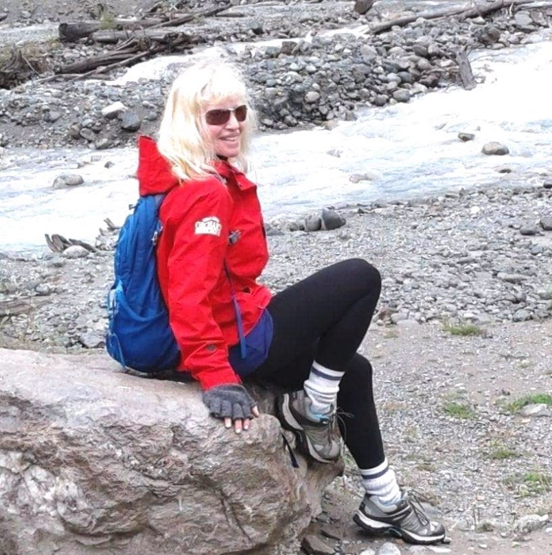 Lisa on a rock on a hike on a mountain