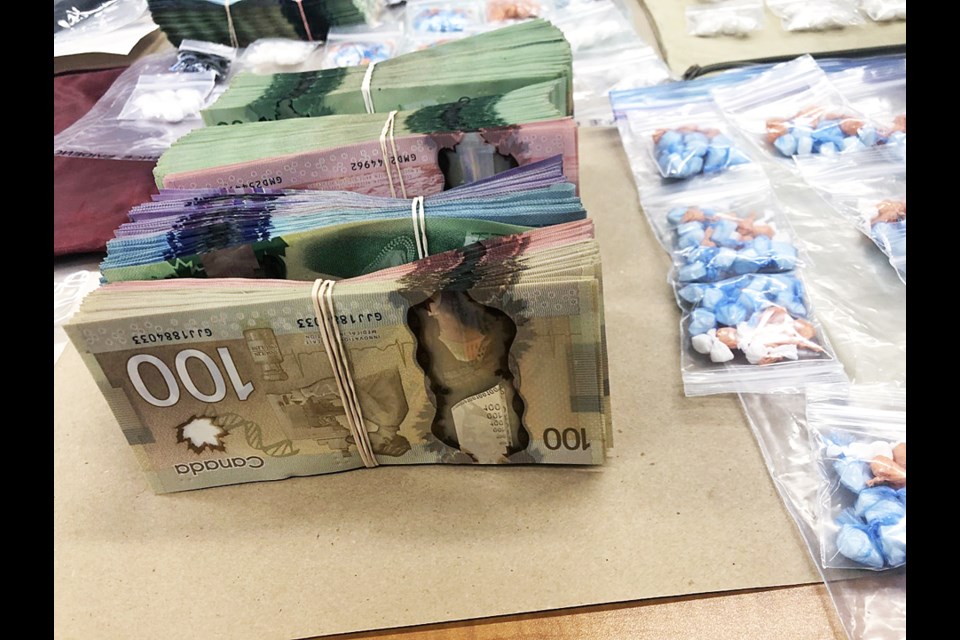 Police seized $20,000 in cash and thousands of prepackaged doses of crack cocaine and fentanyl from a Burnaby apartment that was allegedly being used as a drug processing facility.