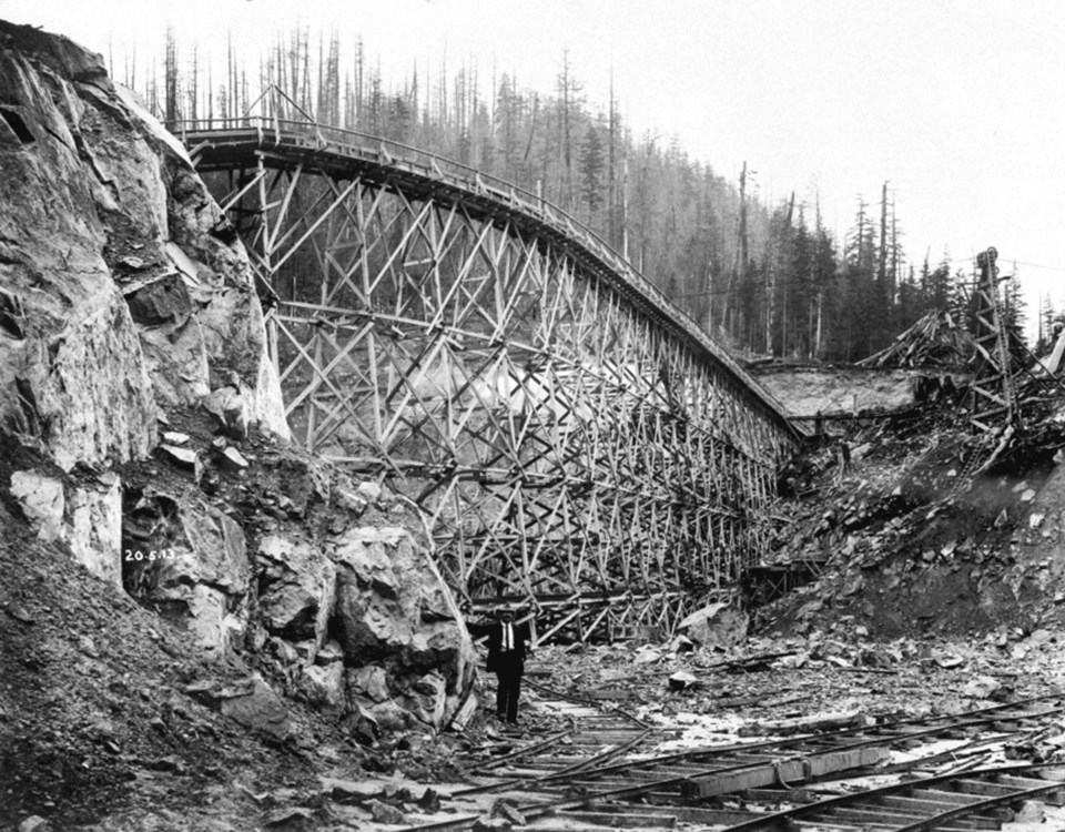 Partially constructed trestle and flume across spillway cut of Coquitlam Dam. Thought to be from May