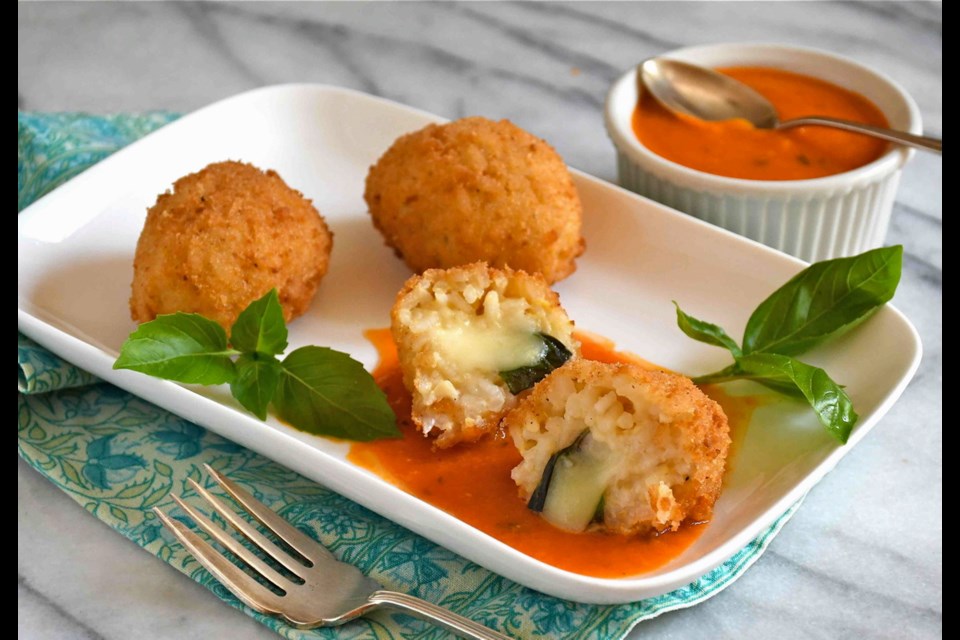 Suppli al Telefono are Italian-style rice croquettes, stuffed with cheese and basil, coated in breadcrumbs, then fried until golden brown.