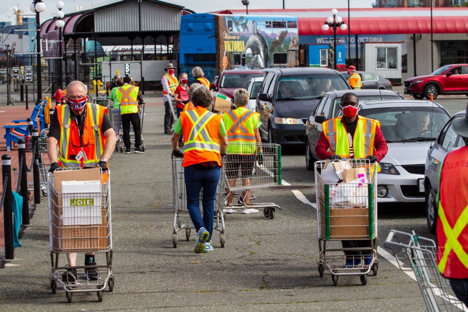 Volunteers work the 2020 edition of the Times Colonist book drive at the Breakwater District at Ogden Point.
