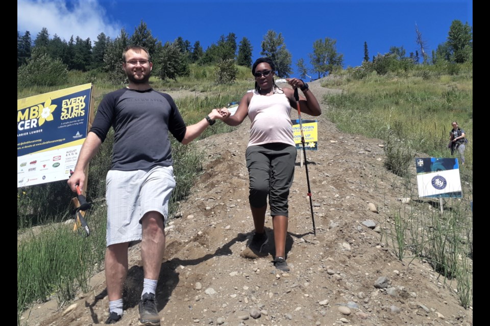 Climb For Cancer participants Eric Depenau and his nine-months-pregnant wife Leila finish off their second trip up and down the Nechako River cutbanks trail Saturday afternoon. The fifth annual event, a fundraiser for the Canadian Cancer Society's Kordyban Lodge, continues Sunday and will resume next weekend.