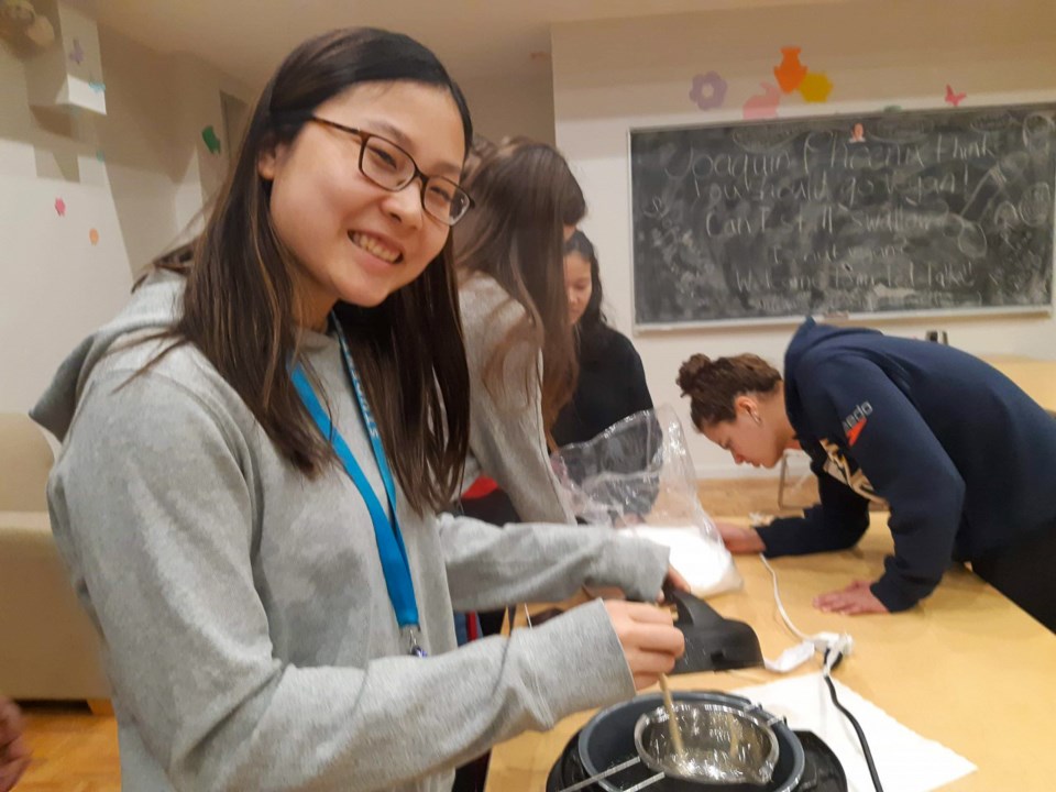 Chenille Wong melts wax for a candle-making event she helped organize as a house council member at U