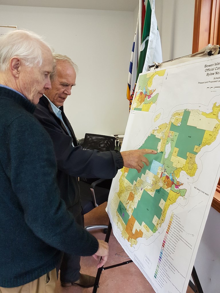 Two men looking at a patchwork map of Bowen