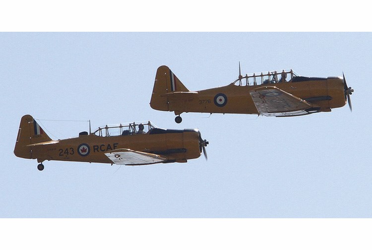 A pair of Harvard military pilot training planes fly in tight formation at the 2012 Vanderhoof International Airshow. A couple of the planes will be flying over Prince George on Saturday, as part of The Great Regional Air Hug of 2020.