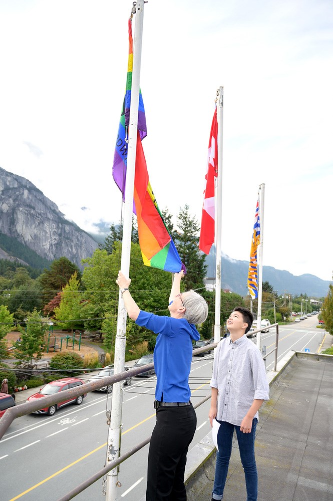 Mayor Karen Elliott raises the Pride flag above muni hall in 2019.