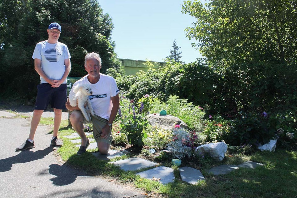 Doug Mitchell (right) and Matthew Lusk (left) built a garden and memorial for neighbourhood dogs who have passed away, and for frontline workers who have worked hard for the community during COVID-19.