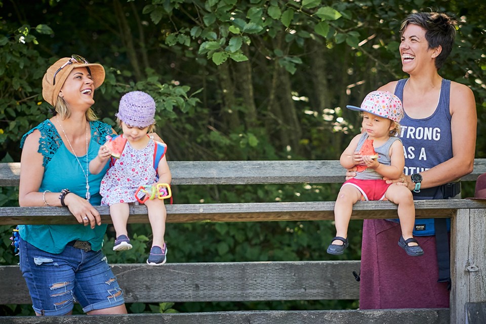 Mandy Zugloff and Amelia Birch with their children.