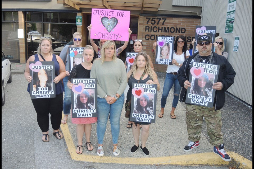 Christy Mahy's family and friends show their support for the Richmond woman killed in 2014, while standing at the intersection of Russ Baker Way and the Dinsmore Bridge. The driver accused of causing her death left Canada after the accident and was only extradited on Tuesday to face the charge. Alan Campbell photo