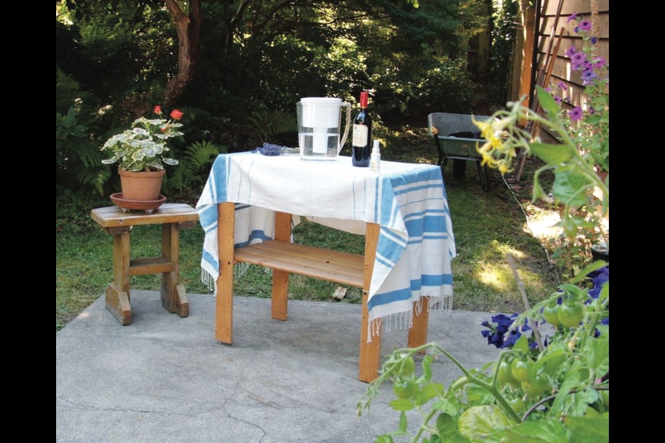 Gatherings of people in small numbers, outdoors, have been among the safest and most pleasant ways to socialize this summer. Here, a table with drinks and hand sanitizer is set up on a patio where potted petunias and tomatoes grow.