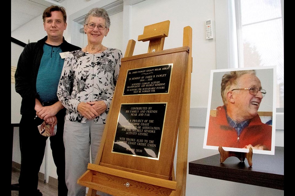 Christine Pawley, the late Jim Pawley’s wife, with their son John Pawley stand in front of the plaque at the Sechelt Seniors Activity Centre.