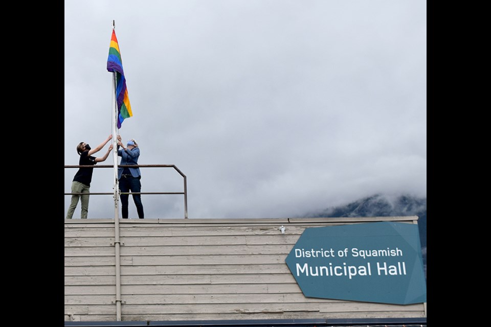 James Fujimagari, youth liaison for Pride Squamish, and Mayor Karen Elliott raise the Pride flag above municipal hall Monday morning at 11 a.m.