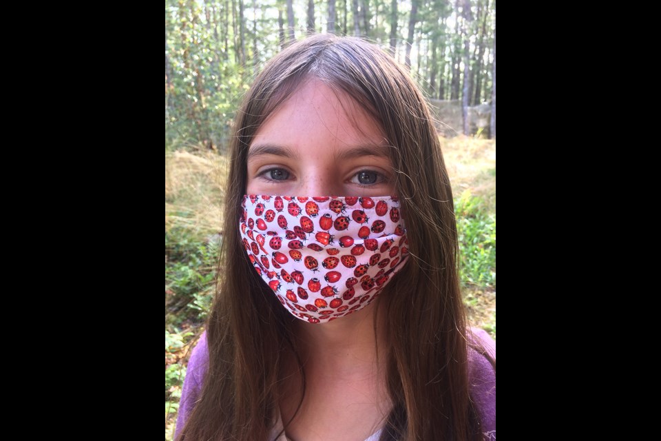 Wrenwin Angell displays a mask handmade by her grandma. Contributed photo.