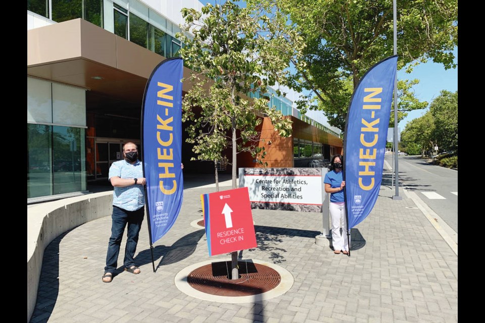 Residence Services staff stand outside the athletic centre where check-in will take place on Sunday for students moving into residence. PHOTO COURTESY RESIDENCE SERVICES