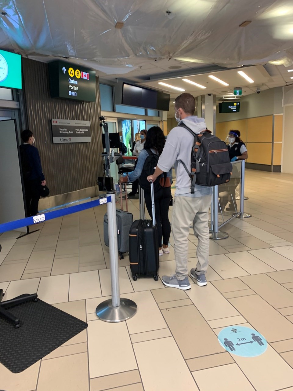 The pre-security temperature check at YVR.