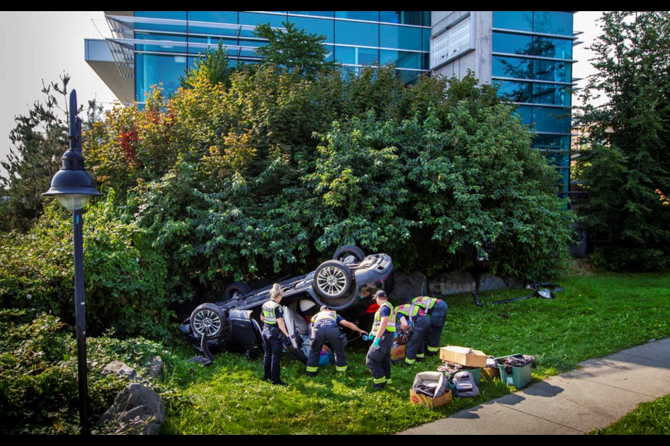Emergency crews clean up after a van flipped over and crashed near the Point Ellice Bridge while heading east across Bay Street and Tyee Road.  DARREN STONE, TIMES COLONIST