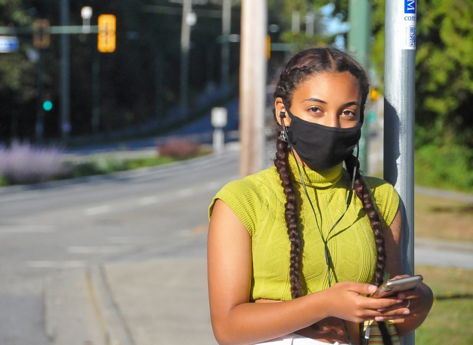 Coquitlam Grade 10 student Tasio Cielo, 15, waits for a bus outside Dr. Charles Best secondary after