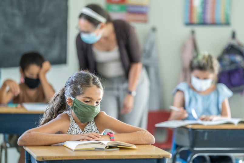 A 12-year old in a classroom.