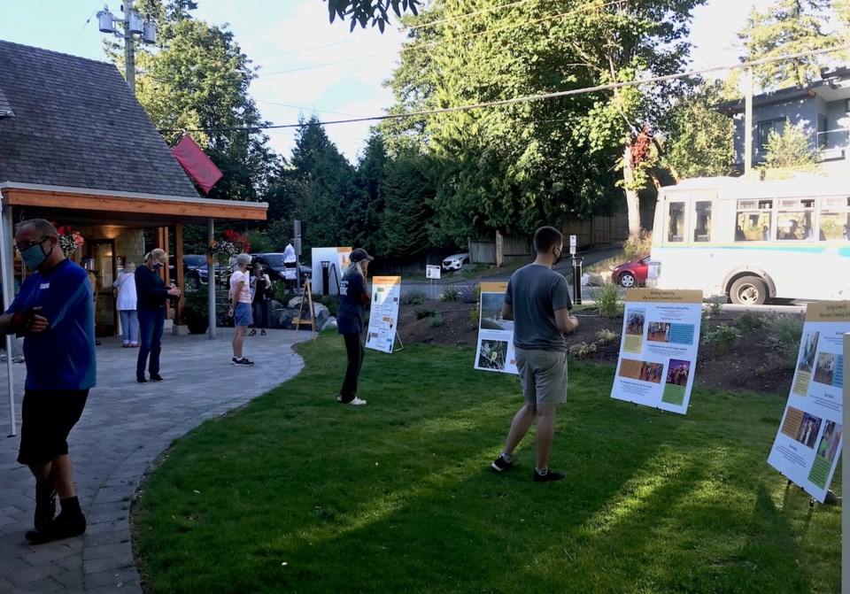 People outside the Hearth Gallery looking at signs