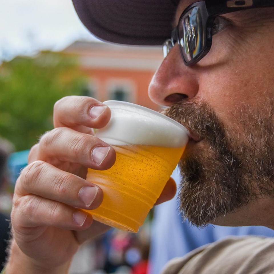 An attendee at last year's inaugural Brew-Haha beer fundraiser tasting some local suds. This year, y