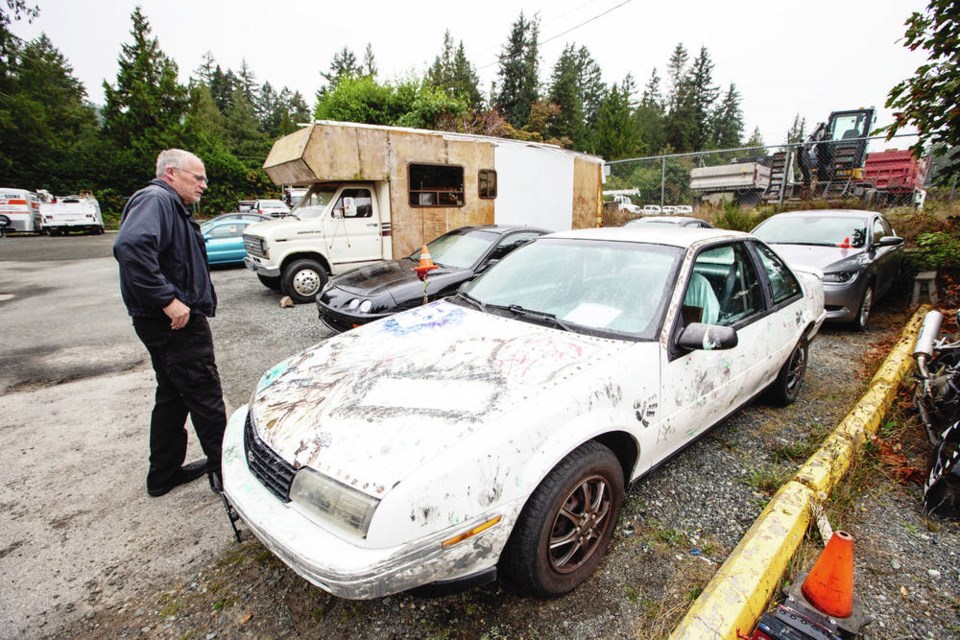 Westshore Towing Ltd. owner Dave LeQuesne with some of the abandoned vehicles hes had to haul. Towing companies say theres so little money in salvaging such vehicles, it doesnt pay the costs of retrieving them. DARREN STONE, TIMES COLONIST