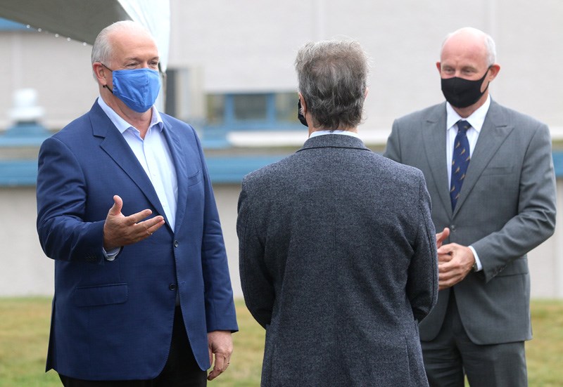 BC NDP leader John Horgan chats with Coquitlam-Burke Mountain candidate Finn Donnelly and Port Coqui