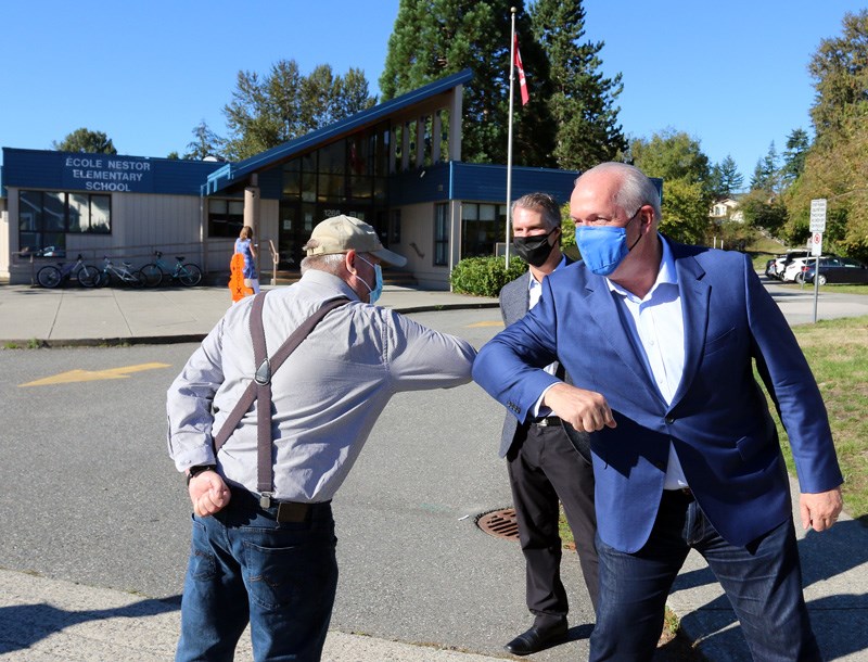 BC NDP leader John Horgan greets a supporter outside Nestor elementary school in Coquitlam where he