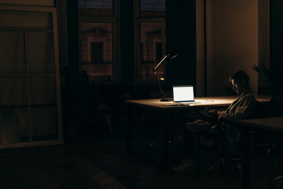 in a dark room, blank computer