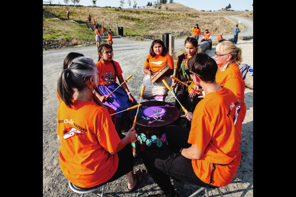 The A.N.S.W.E.R. Drum Group plays at an Orange Shirt Day event Wednesday to honour the Indigenous children who were sent away to residential schools in Canada. The event, which featured a community mural and a market, was held by the Songhees and Esquimalt Nations and the Pacific Peoples Partnership as part of its One Wave Gathering at Royal Beach in Colwood. DARREN STONE, TIMES COLONIST