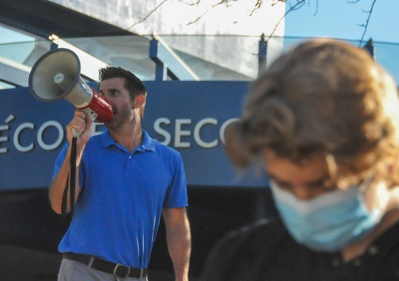 Vice-principal Joel Nelson gives instructions over a loudspeaker