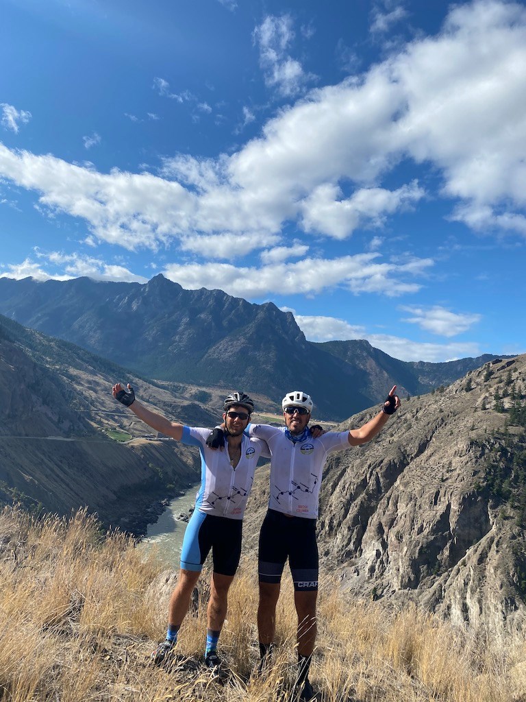 The two men overlooking a mountainous scene