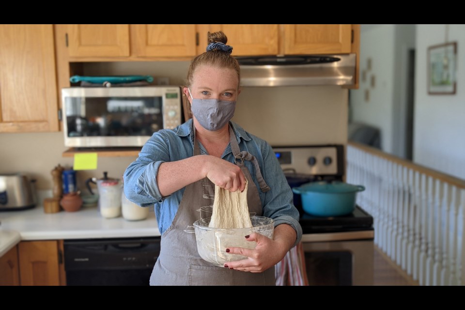 Adel Cotichini prepares sourdough at her home kitchen in Anmore, B.C. The COVID-19 pandemic gave her the time and motivation to launch a home-based bread business.