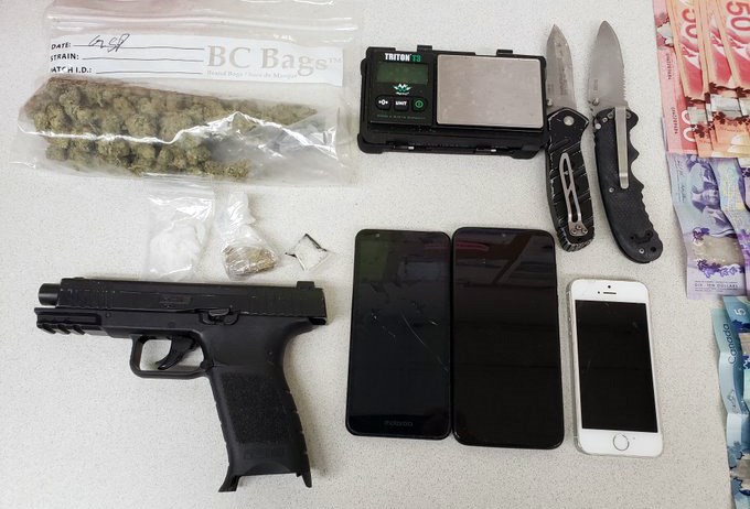 Police seized weapons, drugs and cash from a 28-year-old man who drew the attention of local residents when he fell asleep in an idling, stolen SUV in Burnaby for three hours last month.