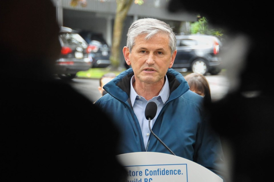 BC Liberal leader Andrew Wilkinson speaks outside Port Moody-Coquitlam candidate James Robertson's h