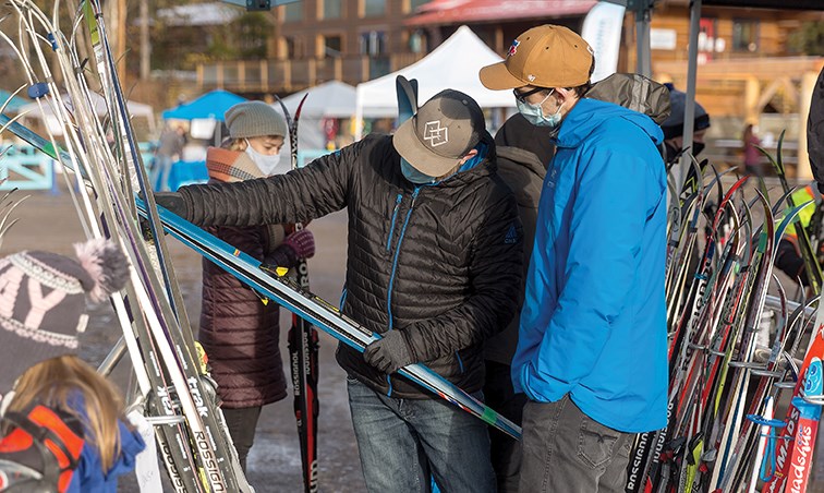 Citizen Photo by James Doyle. A volunteer helps a shopper examine a pair of skis that are for sale on Saturday morning at the Caledonia Nordic Ski Swap and Outdoor Market at the Otway Nordic Centre. Roughly 250 people were lined up when the ski swap opened at 9 a.m.