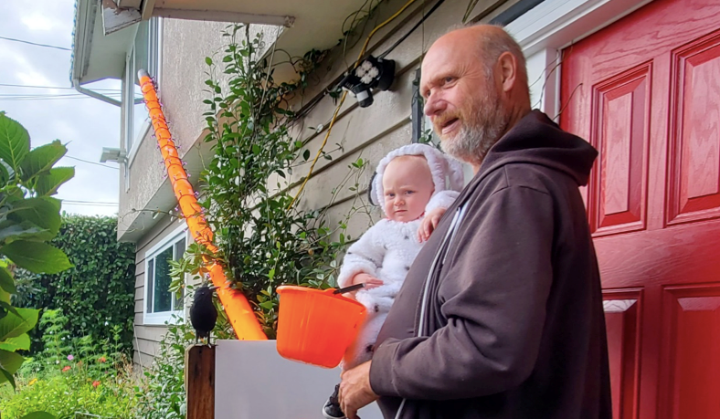 Ray McCurrach with his grandson, Reece Murphy, are ready for Halloween. McCurrach has built a giant candy tube to dispense candy safely during COVID-19.