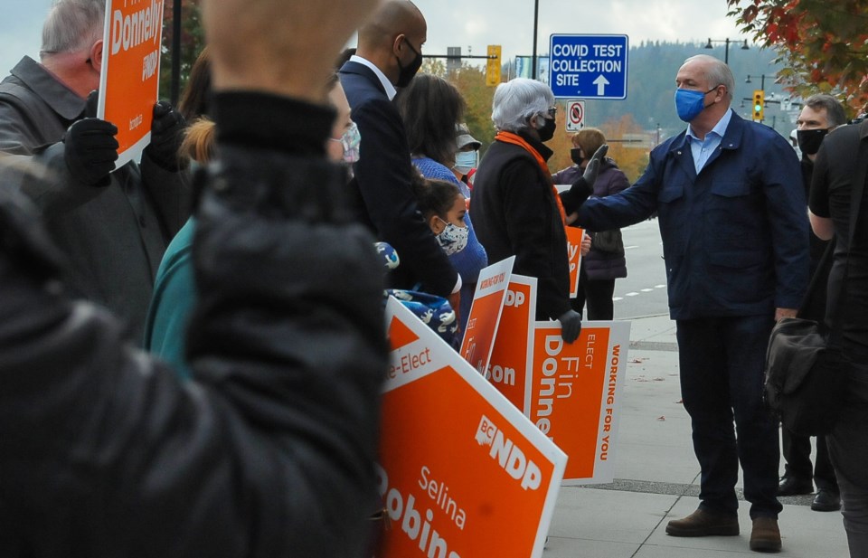 BC NDP Leader John Horgan greets supporters at a sign waving event in Coquitlam Tuesday, Oct. 20.