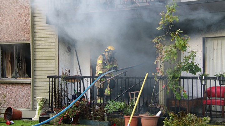 Burnaby firefighters battle a fire at an apartment on Holdom Avenue. Ryan Stelting photo