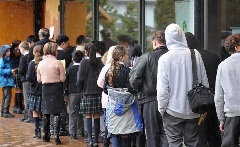 Catholic worshippers line up outside All Saints Parish in Coquitlam in 2018. The church kept its doo