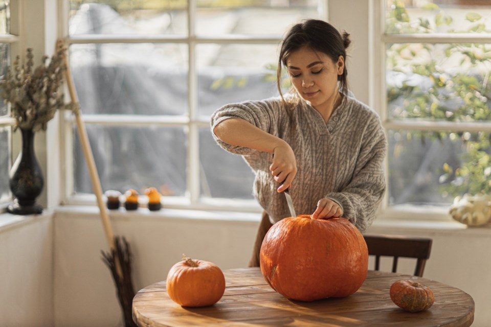 Woman carving a pumpkin