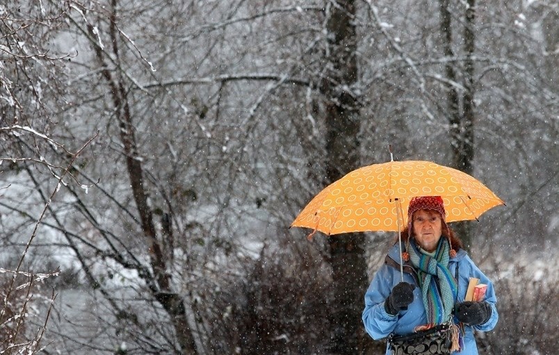 A woman walks through the snow in Coquitlam