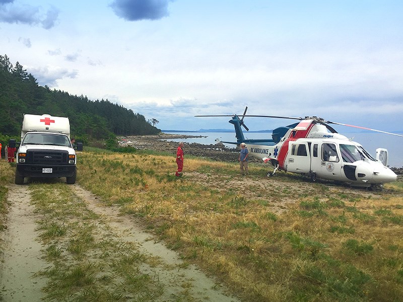 REQUEST ASSISTANCE: qathet Regional District committee of the whole heard a presentation from Savary Island representatives about upgrading Herchmer Road to improve access to one of the helicopter medivac sites on the island. In this photo, the helicopter landed at Sunset Trail on Savary Island. Savary Island Volunteer Fire Department photo