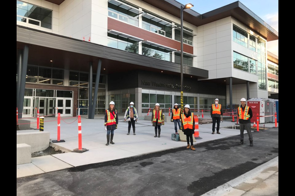 Trustees and senior staff pose outside the new building.